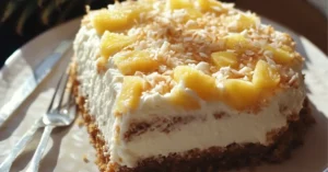 Slice of Hawaiian pineapple cake topped with fresh pineapple chunks and toasted coconut