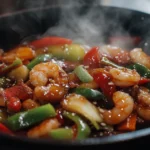 A colorful shrimp stir fry served on a white plate